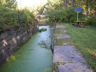 Enlarged Erie Canal Lock 19, south chamber towpath side and historic marker